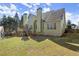 Wide view of back of home and yard including deck at 5025 Hidden Ct, Cumming, GA 30040