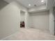 Finished basement space with neutral carpet and recessed lighting at 5025 Hidden Ct, Cumming, GA 30040