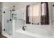 Modern bathroom featuring a luxurious soaking tub, glass-enclosed shower, and elegant fixtures at 5025 Hidden Ct, Cumming, GA 30040