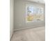 Neutrally decorated bedroom with a large window and carpet at 5025 Hidden Ct, Cumming, GA 30040