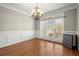 Bright dining room featuring hardwood floors, wainscoting, large windows, and a stylish chandelier at 5025 Hidden Ct, Cumming, GA 30040