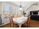 Inviting dining area with a large window view, wooden table, and hardwood flooring, next to the living room at 5025 Hidden Ct, Cumming, GA 30040