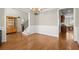 Spacious dining room with hardwood floors, wainscoting, and a view of the foyer and kitchen at 5025 Hidden Ct, Cumming, GA 30040