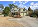 Charming two-story home with a well-manicured front yard and a spacious driveway leading to a two-car garage at 5025 Hidden Ct, Cumming, GA 30040