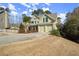 Charming two-story home features a manicured front yard and a spacious driveway leading to a two-car garage at 5025 Hidden Ct, Cumming, GA 30040