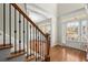 Elegant foyer with hardwood floors, staircase, and a view of the front door with sidelights at 5025 Hidden Ct, Cumming, GA 30040