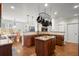 Gourmet kitchen featuring stainless steel appliances, granite counters, an island, and a pot rack at 5025 Hidden Ct, Cumming, GA 30040