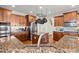 Gourmet kitchen with granite countertops, stainless steel appliances, pot rack, and custom cabinets at 5025 Hidden Ct, Cumming, GA 30040