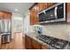 Modern kitchen features stainless steel appliances, and granite countertops with gas range at 5025 Hidden Ct, Cumming, GA 30040