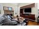 Cozy living room with a stone fireplace, built-in shelving, and a comfortable leather sofa at 5025 Hidden Ct, Cumming, GA 30040