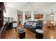 Spacious living room with hardwood floors, open to the kitchen and dining area, and a comfortable leather sofa at 5025 Hidden Ct, Cumming, GA 30040