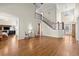 Bright and airy living room with hardwood floors, high ceilings, and a view of the staircase at 5025 Hidden Ct, Cumming, GA 30040