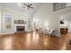 Spacious living room with a fireplace, high ceilings, and hardwood floors with natural light at 5025 Hidden Ct, Cumming, GA 30040