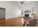 Inviting living room with hardwood floors, fireplace, and plenty of natural light from the windows at 5025 Hidden Ct, Cumming, GA 30040