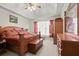Well-lit bedroom with tray ceilings, carpet, and a full furniture set that includes a large bed and dresser at 5025 Hidden Ct, Cumming, GA 30040