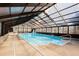 Bright indoor pool area with a slide, hot tub, and ceiling to floor windows letting in natural light at 5025 Hidden Ct, Cumming, GA 30040