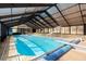 Indoor pool with slide and diving board, surrounded by large windows at 5025 Hidden Ct, Cumming, GA 30040