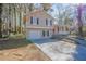 Tan house with red door, attached garage, and landscaped yard at 3794 Whaley Ct, Snellville, GA 30039