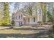 Tan house with red door, attached garage, and landscaped yard at 3794 Whaley Ct, Snellville, GA 30039