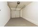 Spacious garage with overhead door and painted floor at 3794 Whaley Ct, Snellville, GA 30039