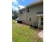Spacious backyard with lush lawn, neutral siding, and convenient outdoor utilities at 2080 Winding Crossing Trl, Fairburn, GA 30213