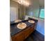 Bathroom with dual sinks, wood cabinets, and a large mirror at 2080 Winding Crossing Trl, Fairburn, GA 30213