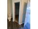 Compact bathroom includes a toilet and opens to a storage closet at 2080 Winding Crossing Trl, Fairburn, GA 30213