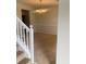 Dining area featuring a chandelier, accessible from carpeted stairs with white railings at 2080 Winding Crossing Trl, Fairburn, GA 30213