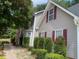 Side view of a house with neatly trimmed shrubs and a walkway at 2080 Winding Crossing Trl, Fairburn, GA 30213