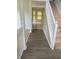 Entryway view showing hardwood floors, staircase, and a glimpse into an adjacent room at 2080 Winding Crossing Trl, Fairburn, GA 30213