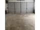 A garage interior with a concrete floor and a closed sectional door at 2080 Winding Crossing Trl, Fairburn, GA 30213