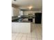 Kitchen with white cabinets, black countertops, black appliances, and tile flooring at 2080 Winding Crossing Trl, Fairburn, GA 30213