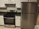 Kitchen with white cabinets, stainless steel appliances, and tile flooring at 2080 Winding Crossing Trl, Fairburn, GA 30213
