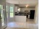 Kitchen with white cabinets, black appliances and granite countertops, bathed in natural light at 2080 Winding Crossing Trl, Fairburn, GA 30213