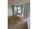 Spacious living room with carpet, bay windows, and neutral wall paint at 2080 Winding Crossing Trl, Fairburn, GA 30213