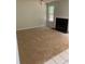 Living room with neutral carpet, a fireplace, and natural light from a window at 2080 Winding Crossing Trl, Fairburn, GA 30213