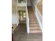 Staircase with white railing leading to an upper level at 2080 Winding Crossing Trl, Fairburn, GA 30213