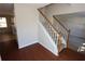 Hardwood floors and a staircase with white railing at 5488 Silver Springs Dr, Sugar Hill, GA 30518