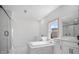 Bright, spa-like bathroom featuring dual vanities, a soaking tub, and a glass-enclosed shower at 6745 Dahlgren Ct, Cumming, GA 30028
