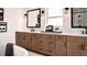 Luxurious bathroom featuring double vanity, wood cabinets, and modern fixtures at 6745 Dahlgren Ct, Cumming, GA 30028