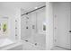 Bathroom features a glass shower and tub at 6745 Dahlgren Ct, Cumming, GA 30028
