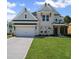 Beautiful two-story home with white brick, a two-car garage, and professionally landscaped front yard at 6745 Dahlgren Ct, Cumming, GA 30028