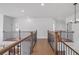 Open hallway with hardwood floors and modern railings at 6745 Dahlgren Ct, Cumming, GA 30028