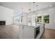 Bright kitchen with a large island, modern appliances, and an open floor plan perfect for entertaining guests at 6745 Dahlgren Ct, Cumming, GA 30028