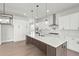 Modern kitchen with white cabinets, a large island, and stainless steel appliances at 6745 Dahlgren Ct, Cumming, GA 30028