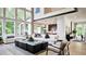 Spacious living room with hardwood floors, large windows, and modern furniture at 6745 Dahlgren Ct, Cumming, GA 30028