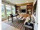 Well-lit office with custom built-ins, a desk, and comfortable seating area at 6745 Dahlgren Ct, Cumming, GA 30028