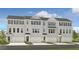 Three-story townhouses with gray brick, garages, and front landscaping at 213 Maycrest Path, Tucker, GA 30084