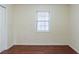 Empty bedroom with hardwood floors and a window at 300 Rocky Cove Trl, Lawrenceville, GA 30044