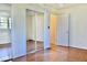 Bedroom with mirrored closet doors and wood floors at 4653 Flat Bridge Sw Rd, Stockbridge, GA 30281